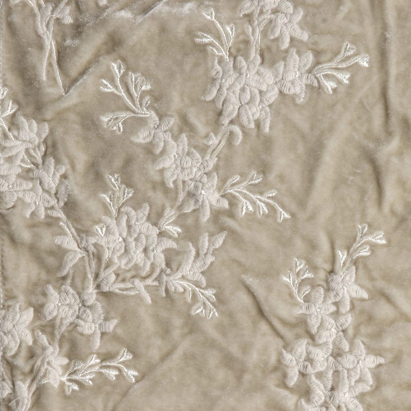 Lynette Blanket | Parchment | A close up of embroidered silk velvet fabric in parchment, a warm, antiqued cream.