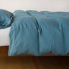 Madera Luxe Twin Duvet Cover | Cenote | duvet cover with matching sleeping pillow and fitted sheet - side view.