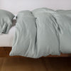 Madera Luxe Duvet Cover | Eucalyptus | duvet cover with matching sleeping pillow and fitted sheet - side view.