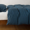 Madera Luxe Duvet Cover | Midnight | duvet cover with matching sleeping pillow and fitted sheet - side view.