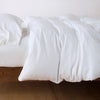 Madera Luxe Twin Duvet Cover | White | duvet cover with matching sleeping pillow and fitted sheet - side view.