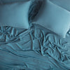 Madera Luxe Twin Fitted Sheets | Cenote | rumpled sheeting and sleeping pillows - overhead view.