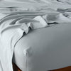 Madera Luxe Fitted Sheet | Mineral | fitted sheet with matching rumpled flat sheet - top corner view.