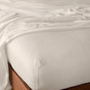 Madera Luxe Twin Fitted Sheets | Parchment | fitted sheet with matching rumpled flat sheet - top corner view.
