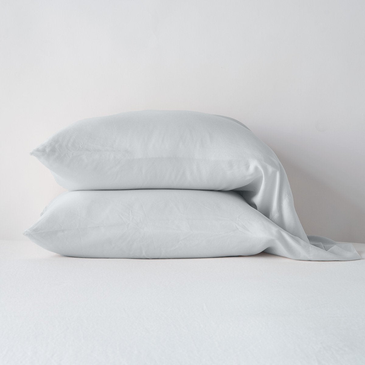 Madera Luxe Pillowcase (Single) | Cloud | sleeping pillows stacked neatly against a white backdrop - side view.
