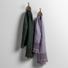 Mattine Guest Towel | mattine lace trimmed linen guest towels in juniper and french lavender hanging from decorative towel hooks against a white wall.