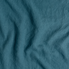 Austin Sham | Cenote | A close up of midweight linen fabric in cenote, a vibrant, ocean-inspired blue-green.