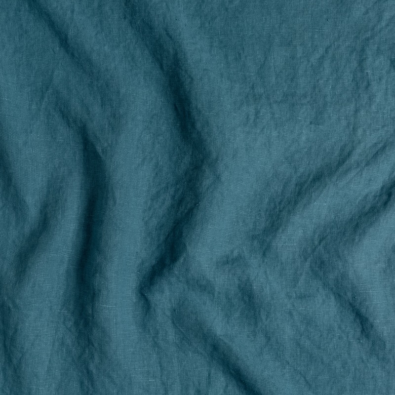 Austin Sham | Cenote | A close up of midweight linen fabric in cenote, a vibrant, ocean-inspired blue-green.