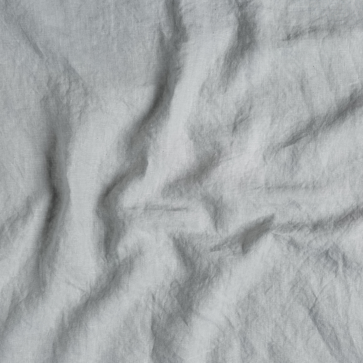 Midweight Linen Swatch Card | Cloud | A close up of midweight linen fabric in cloud, a soft, subtle sky blue-grey.