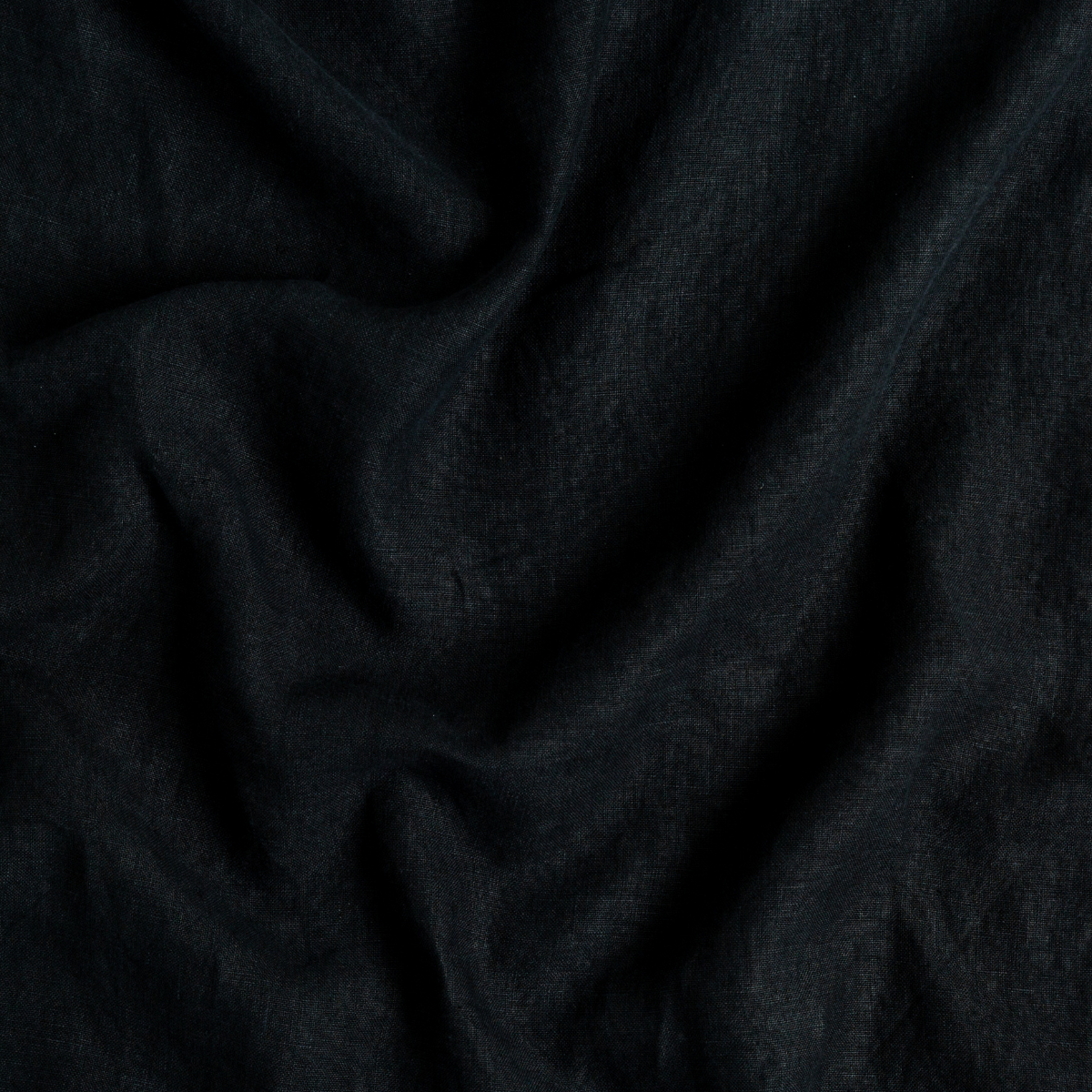 Austin Bed Skirt | Corvino | A close up of midweight linen fabric in Corvino, a black tone.
