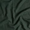 Austin Sham | Juniper | A close up of midweight linen fabric in Juniper, a deep green tone.