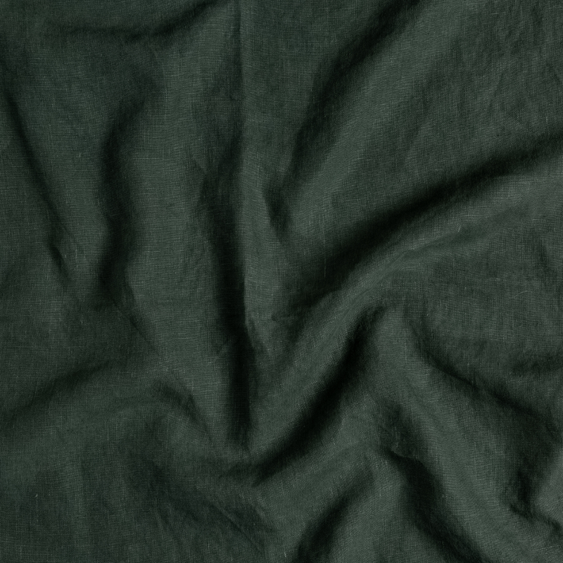 Austin Guest Towel | Juniper | A close up of midweight linen fabric in Juniper, a deep green tone.