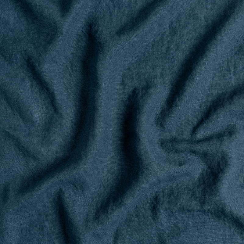 Austin Bed Skirt | Midnight | A close up of midweight linen fabric in midnight, a rich indigo tone.