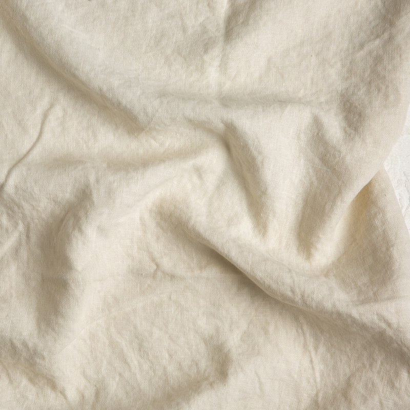 Austin Sham | Parchment | A close up of midweight linen fabric in parchment, a warm, antiqued cream.