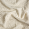 Midweight Linen Swatch | Parchment | A close up of midweight linen fabric in parchment, a warm, antiqued cream.