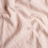 Austin Sham | Pearl | A close up of midweight linen fabric in pearl, a nude-like, soft rose pink tone.