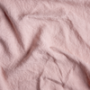 Austin Bed Skirt | Rouge | A close up of midweight linen fabric in rouge, a mid-tone blush pink.