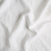 Austin Bed Skirt | White | A close up of midweight linen fabric in classic white.
