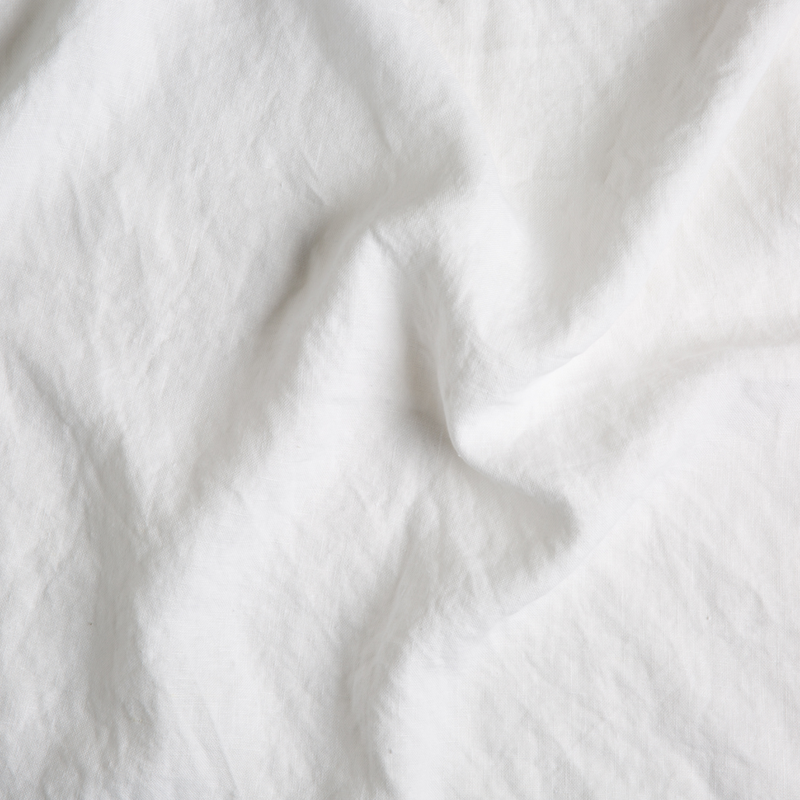 Austin Sham | White | A close up of midweight linen fabric in classic white.