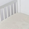 Mirabella Crib Sheet — Limited Release | Parchment | a silk and tencel™ crib sheet shown slightly overhread and shot into the corner of a white crib.