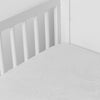 Mirabella Crib Sheet — Limited Release | Winter White | a silk and tencel™ crib sheet shown slightly overhread and shot into the corner of a white crib.