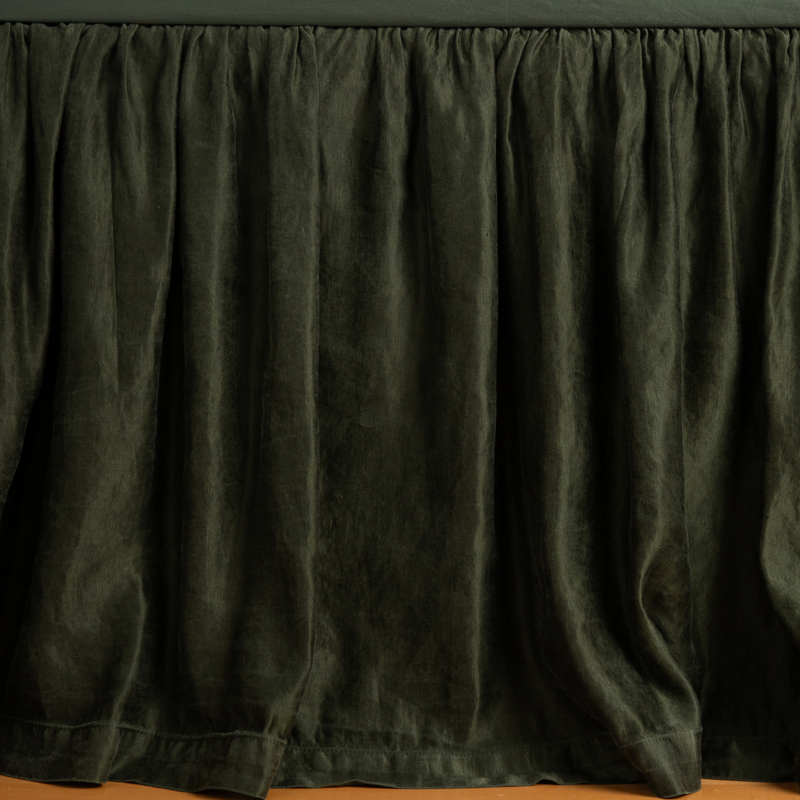 Paloma Bed Skirt | Juniper | charmeuse bed skirt panel with matching fitted sheet - shot with an emphasis on the skirt with its edge barely dusting the floor.