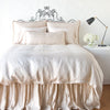 Paloma bed skirt with matching duvet, and pillows - pearl, end of bed view.