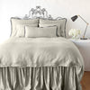 Paloma Duvet Cover | Fog | duvet cover with matching pillows and bed skirt - end of bed view.