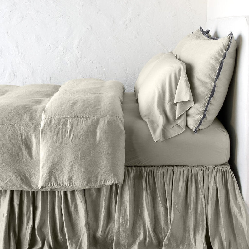 Paloma Duvet Cover | Fog | duvet cover with matching pillows and bed skirt - side view.