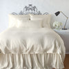 Paloma Duvet Cover | Parchment | duvet cover with matching pillows and bed skirt - end of bed view.