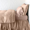 Paloma Duvet Cover | Rouge | duvet cover with matching pillows and bed skirt - side view.