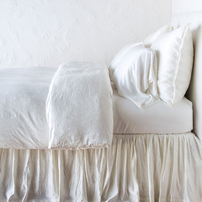 Paloma Duvet Cover | Winter White | duvet cover with matching pillows and bed skirt - side view.