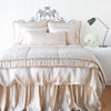Paloma Blanket | Pearl | throw blanket folded at the end of a monochromatic, charmeuse bed - end of bed view.