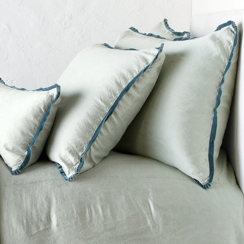 Eucalyptus | Paloma shams and lumbar pillow on a matching duvet cover - eucalyptus, cropped side view.