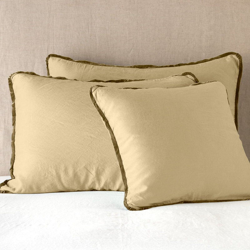Paloma Sham | Honeycomb | shams leaning upright on white sheeting against a neutral headboard.