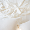 Seraphina Pillowcase (Single) | Rumpled Seraphina sheeting and sleeping pillows in winter white - overhead view.