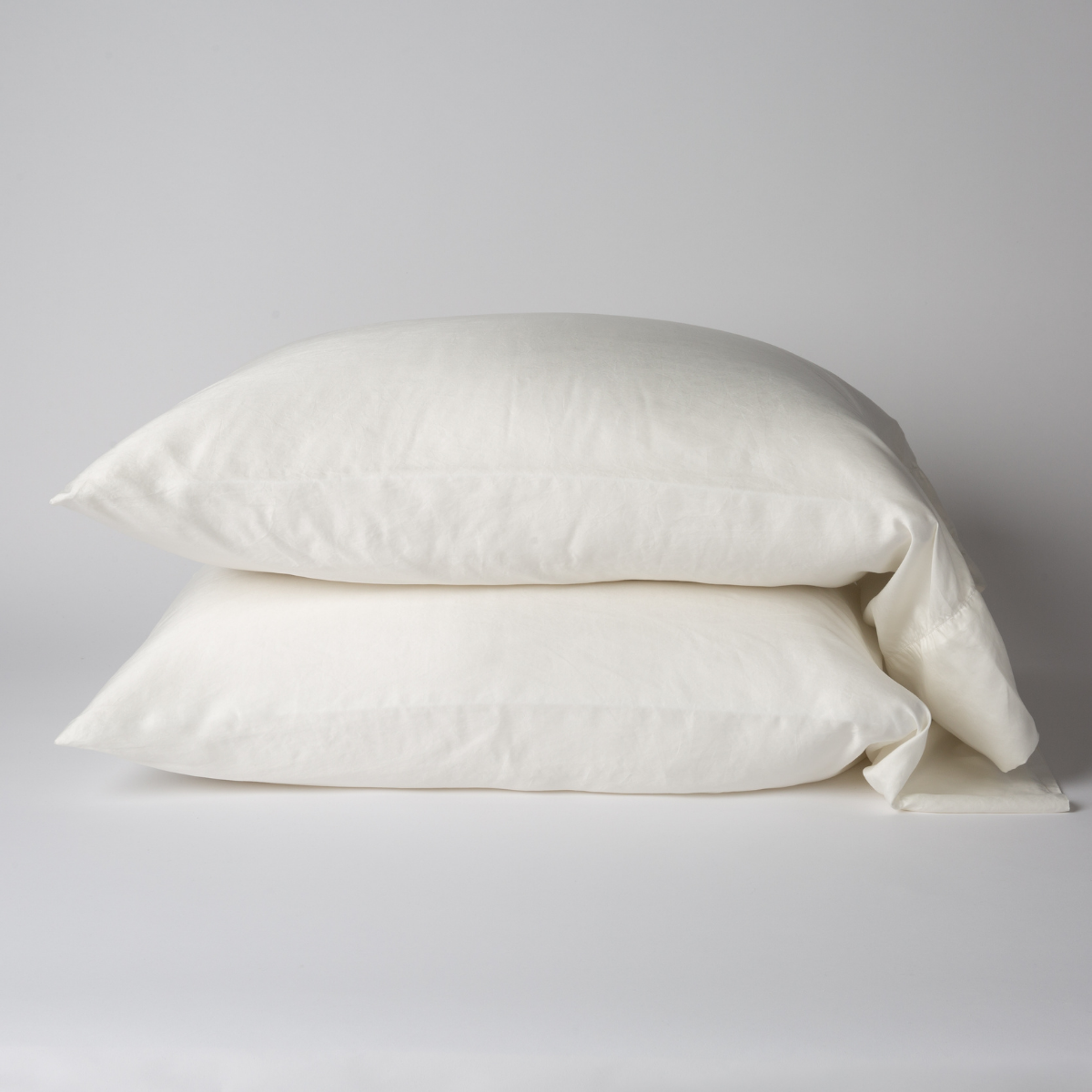 Seraphina Pillowcase (Single) | Winter White | sleeping pillows, stacked flat against a white background - side view.