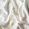 Seraphina Swatch Card | Winter White | A close up our silk-Tencel™ blend, in winter white, softer and warmer in tone than classic white.
