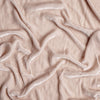 Carmen Baby Blanket | Pearl | A close up of silk velvet fabric in pearl, a nude-like, soft rose pink tone.