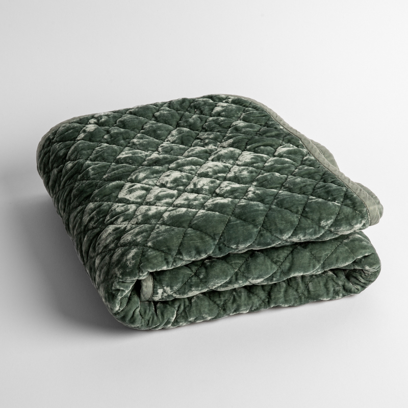 Silk Velvet Quilted Baby Blanket | Eucalyptus | a folded quilted silk velvet baby blanket shown from overhead to showcase quilting  pattern and texture.