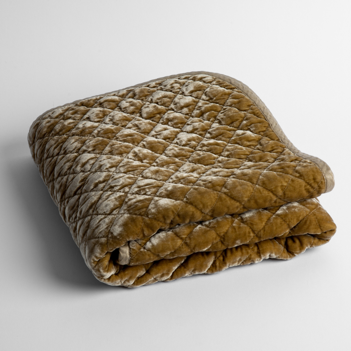Silk Velvet Quilted Baby Blanket | Honeycomb | a folded quilted silk velvet baby blanket shown from overhead to showcase quilting  pattern and texture.