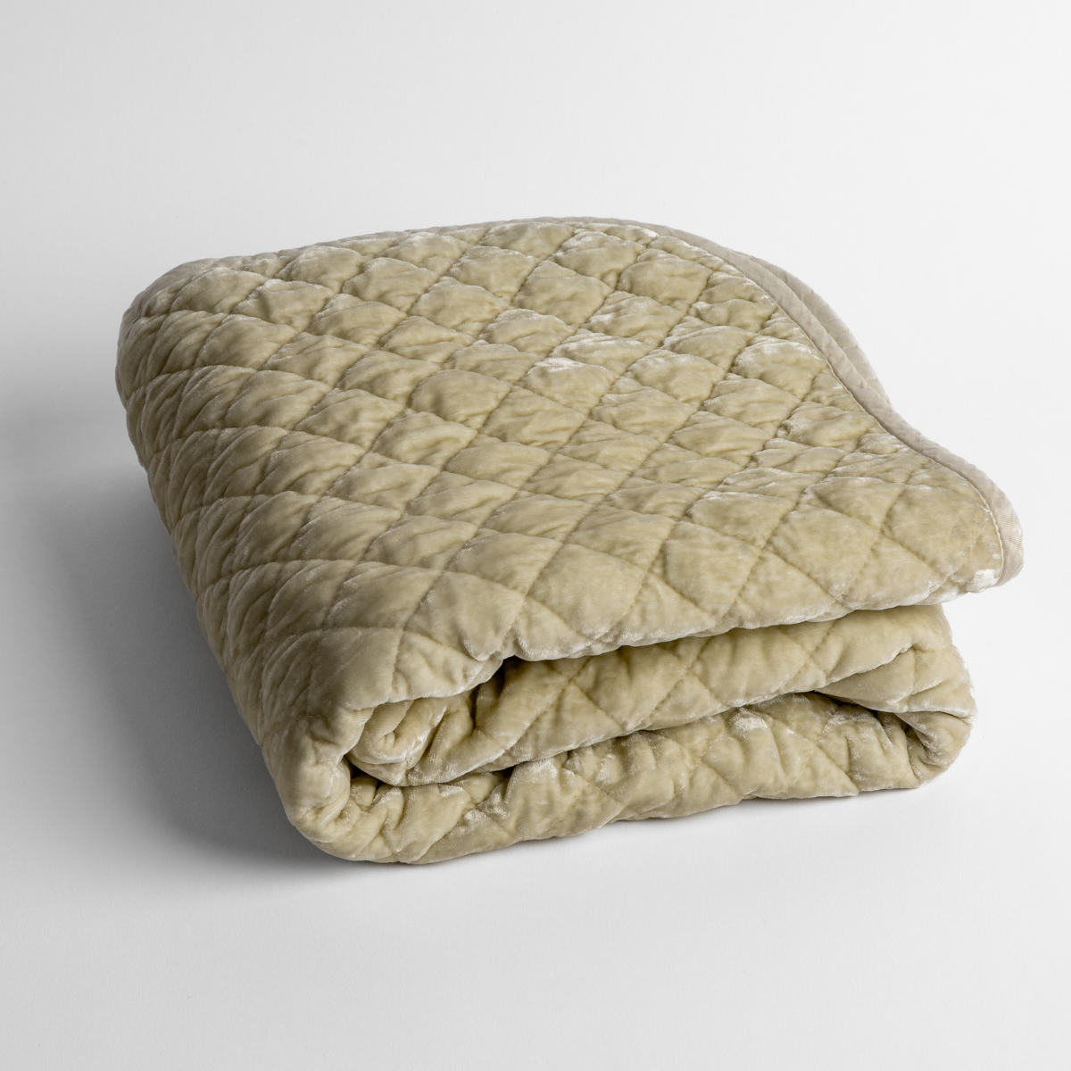 Silk Velvet Quilted Baby Blanket | Parchment | a folded quilted silk velvet baby blanket shown from overhead to showcase quilting  pattern and texture.