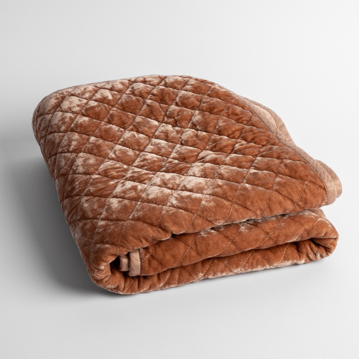 Silk Velvet Quilted Baby Blanket | Rouge | a folded quilted silk velvet baby blanket shown from overhead to showcase quilting  pattern and texture.