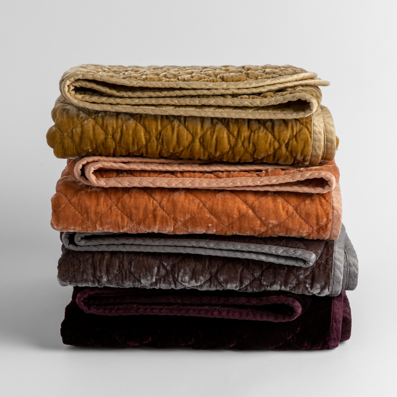 Silk Velvet Quilted Baby Blanket | stack of 4 quilted silk velvet baby blankets in honeycomb, rouge, moonlight and fig against a white background. 