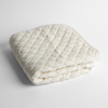 Silk Velvet Quilted Baby Blanket | Winter White | a folded quilted silk velvet baby blanket shown from overhead to showcase quilting  pattern and texture.
