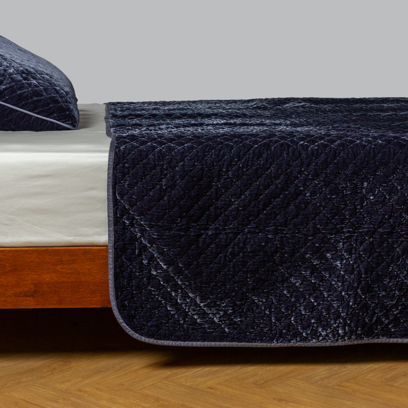 Silk Velvet Quilted Coverlet | French Lavender | quilted silk velvet coverlet with matching sham on a winter white fitted sheet - side view.