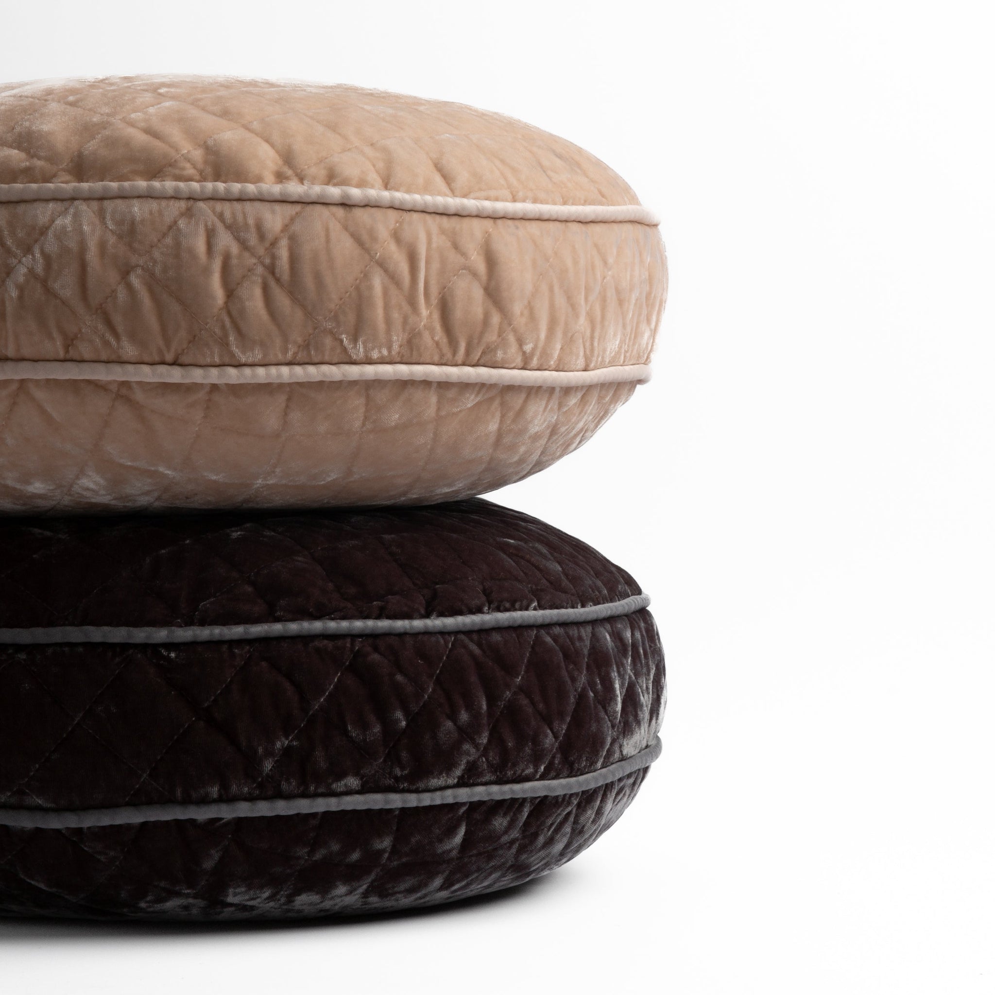 Silk Velvet Quilted Throw Pillow | two 18" round pillows stacked and shot straight on against a white background, pillows shown in Pearl and Moonlight.