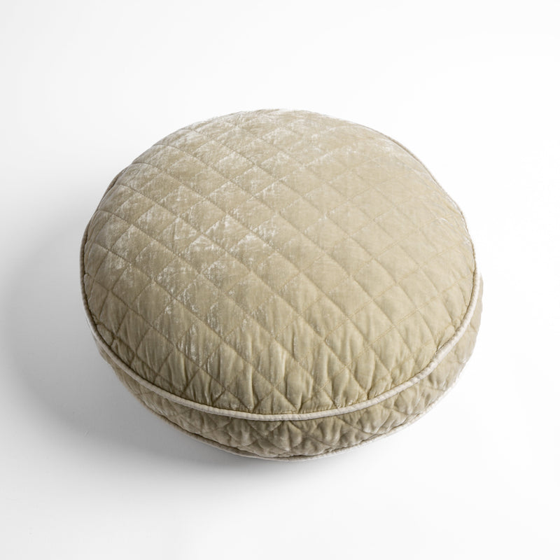 Silk Velvet Quilted Throw Pillow | Parchment | overhead at a slight angle against a white background, the face and gusset of the pillow are visible.