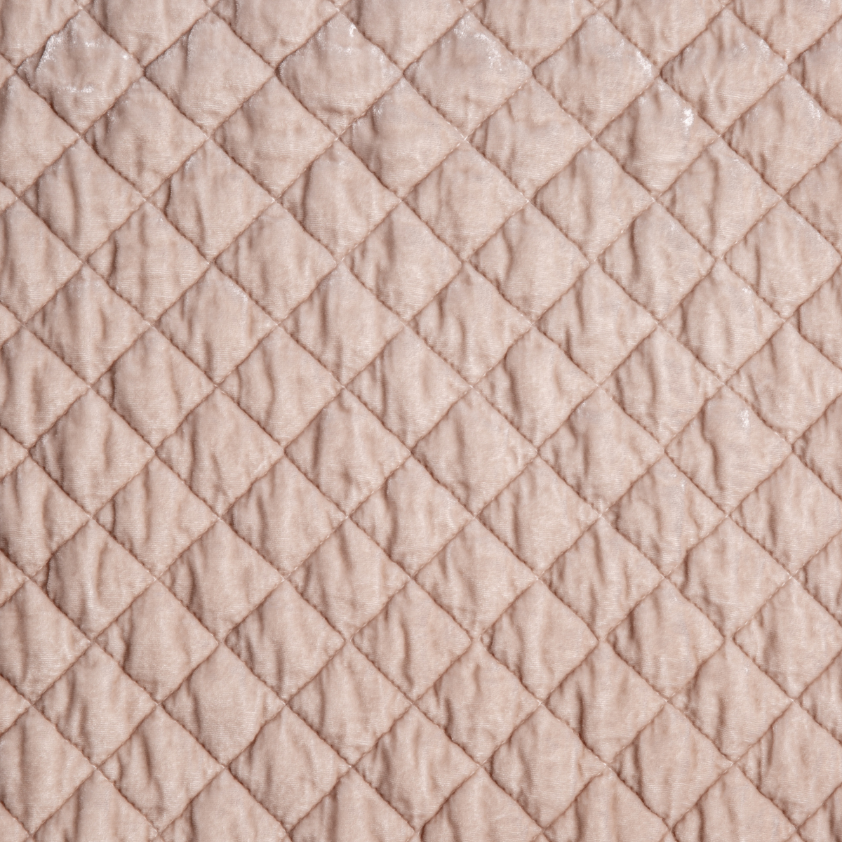 Silk Velvet Quilted Coverlet | Pearl | A close up of quilted silk velvet fabric in pearl, a nude-like, soft rose pink tone.