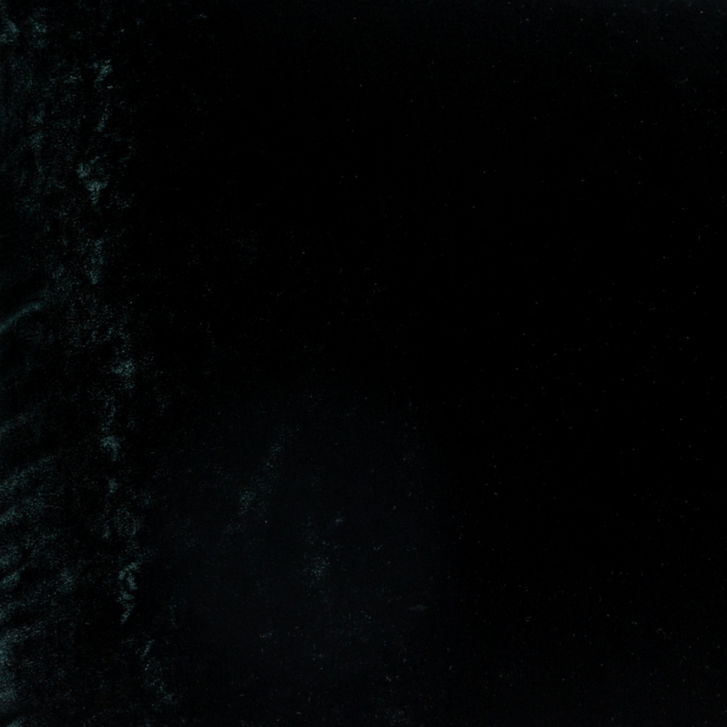 Carmen Blanket | Juniper | A close up of silk velvet fabric in Juniper, a deep green tone.